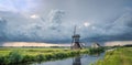 Evening panorama of a windmill and thundery showers over the dutch landscape