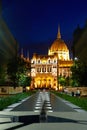 Evening photo of the Parliament building in Budapest. The majestic Saxon architecture is illuminated with warm yellow light Royalty Free Stock Photo