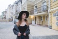 Evening portrait of a stylish woman against the background of the beautiful architecture of the old town. Royalty Free Stock Photo