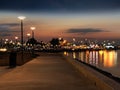 Evening promenade at sea street lamp blurred light blue starry sky sea water reflection  harbor  Tallinn at Baltic sea Travel to E Royalty Free Stock Photo