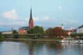 Evening river, embankment and church. Frankfurt am Main, Germany