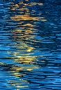 Evening river water texture with light reflection from a lantern