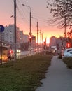 Evening rush hour at sunset, cars are parked at the intersection of a city road against the background of a delicate Royalty Free Stock Photo