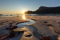 Evening on the sandy beach with the creek on the foreground Royalty Free Stock Photo