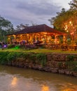 Illuminated outdoor restaurant by river