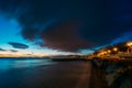 Evening on sea resort after sunset, colorful cloudy sky above sea waves and coastline in twilight Royalty Free Stock Photo