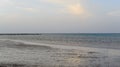 Evening sea shore yacht on the horizon and pier Royalty Free Stock Photo