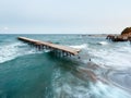 Evening sea surf, ruined pier and Moon in sky (Black Sea, Bulgar