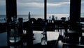 Evening sea view in stylish restaurant. Served event tables in lounge hotel bar Royalty Free Stock Photo