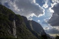 Evening shot of beautiful fjord valley, surrounded by mountains, cloudy blue skies