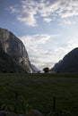 Evening shot of beautiful fjord valley, surrounded by mountains, cloudy blue skies