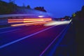 Evening shot of trucks doing transportation and logistics on a highway. Highway traffic - motion blurred truck on a highway motorw Royalty Free Stock Photo