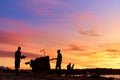 An evening silhouette of a vendor and his grill cart on the beach. Evening market on the beach Royalty Free Stock Photo