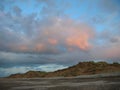 Evening sky with dark rainclouds and fiery sunlight reflections at Findhorn Bay, Scotland Royalty Free Stock Photo