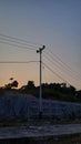 Evening sky with electric poles and wires Royalty Free Stock Photo