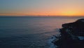 Evening sky marine horizon drone view. Tranquil deep ocean with cliff silhouette Royalty Free Stock Photo