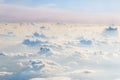 Evening sky over fluffy curly clouds. View from airplane. Beautiful skyline background. Soft focus Royalty Free Stock Photo