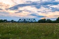 Evening sky over the railway bridge and flowered Bogolyubovo meadow, Vladimir region. Royalty Free Stock Photo