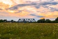 Evening sky over the railway bridge and flowered Bogolyubovo meadow, Vladimir region. Royalty Free Stock Photo