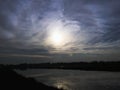 Evening Sky and Sunshine and Black Clouds over water