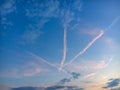 Evening sky with three crossed traces of planes and growing moon Royalty Free Stock Photo