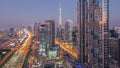 Evening skyline with modern skyscrapers and traffic on sheikh zayed road day to night timelapse in Dubai, UAE. Royalty Free Stock Photo