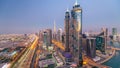 Evening skyline with modern skyscrapers and traffic on sheikh zayed road day to night timelapse in Dubai, UAE. Royalty Free Stock Photo