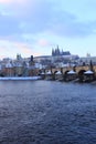 Evening snowy Prague gothic Castle with Charles Bridge, Czech Republic Royalty Free Stock Photo