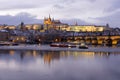 Evening Christmas snowy Prague Lesser Town with gothic Castle, St. Nicholas` Cathedral and Charles Bridge, Czech republic Royalty Free Stock Photo