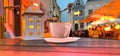 Evening street cup of coffee on restaurant table medieval city street lantern old house people relaxing cozy Tallinn old town tra
