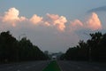 Evening suburbian road with pink sunset Royalty Free Stock Photo