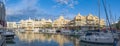 The evening sun illuminates the snow-white yachts in the port of Puerto Marina in Benalmadena