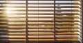 Evening sun light outside wooden window blinds, sunshine and shadow on window blinds. Generative AI