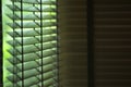 Evening sun light outside wooden window blinds, sunshine and shadow on window blind, decorative interior in home Royalty Free Stock Photo