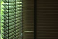 Evening sun light outside wooden window blinds, sunshine and shadow on window blind, decorative interior in home Royalty Free Stock Photo