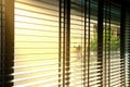 Evening sun light outside wooden window blinds, sunshine and shadow on window blinds , decorative interior home Royalty Free Stock Photo