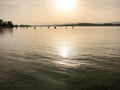 Evening sun and light over lake with reflections and peaceful ripples in Lake Murten in Switzerland Royalty Free Stock Photo