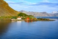 Evening sun over mountains and King Edward Point Research Station of Grytviken with reflections in ocean, South Georgia