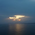 Evening sun over the sea. Cloudy sky Royalty Free Stock Photo