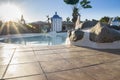 Evening sun rays over a small pool area with blue water Royalty Free Stock Photo