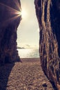 Sun glinting through a cave at Bussaglia beach in Corsica Royalty Free Stock Photo