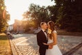 Evening sunlight illuminates lovely wedding couple