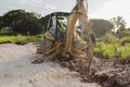 Excavator jackhammer Lowering In Trench At Side Of Road Construction Site Royalty Free Stock Photo