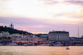 Evening sunset city view with cars and buildings