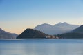 Evening sunset at Como lake with small boat at foreground and mountains at background, Italy. Royalty Free Stock Photo