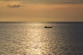 Evening Sunset and fisherman fishing from afar in Tanjung Aru Beach, Sabah.