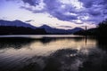 Evening sunset at Lake Bled in Slovenia. Enlightened church on the island, castle ba rock and mountains in the setting sun. Royalty Free Stock Photo