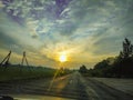 Evening sunset on the road through the car Royalty Free Stock Photo