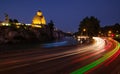 Evening Tbilisi street traffiv long exposure lights with the Statue of King Vakhtang next to the Metekhi Church on the rocky bank