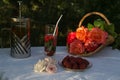 Evening tea and fruit at sunset. Roses glow in the sunset